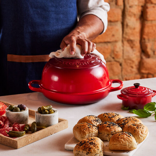 https://www.kitchenkapers.com/cdn/shop/products/le-creuset-bread-oven-cerise-lifestyle_512x512.png?v=1675188122